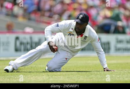 England's Michael Carberry slides on the grass as he fields the ball on the third day of their Ashes cricket test match against Australia in Sydney, Australia, Sunday, Jan. 5, 2014. (AP Photo/Rob Griffith)