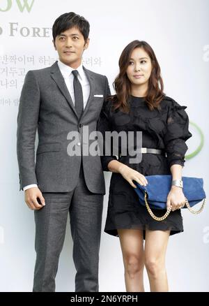 South Korean actor Jang Dong-gun, left, and his wife and actress Ko So-young pose for the media upon their arrival for South Korean actor Lee Byung-hun and his bride and actress Rhee Min-jung's wedding ceremony in Seoul, South Korea, Saturday, Aug. 10, 2013. (AP Photo/Lee Jin-man)