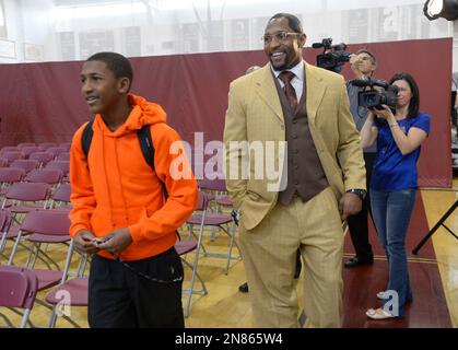 Former Baltimore Ravens linebacker Ray Lewis Jr., second from left, his  sons Rayshad, 14, left, Rahsaan, 12, second from right, and the mother Lewis'  three sons, Tatyana McCall, arrive for a national