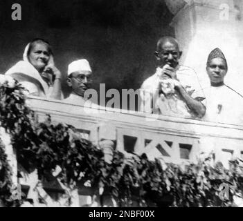 Mohandas Gandhi showing himself to the crowds and acknowledging cheers from the balcony of his host’s bungalow in Ahmedabad, India around on March 30, 1931. His wife Kasturba Gandhi is seen on the left. Gandhi had recently completed talks with Lord Irwin, unseen. (AP Photo)