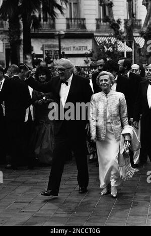 Italian film director Federico Fellini waves as he walks with his wife, Italian actress Giulietta Masina at the 27th International Film Festival in Cannes, France, on May 18, 1974. (AP Photo/Jean Jacques Levy)