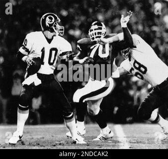 Washington Redskins wide receiver Art Monk (81) is stopped in his tracks by  New York Giants iinebacker Harry Carson (53) as he receives a Jay Schroeder  pass in the third quarter action