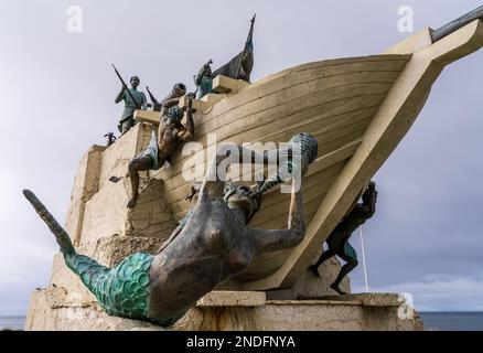 Punta Arenas, Chile - 27 de enero de 2023: Monumento a Magallanes y su barco con sirenas en frente de agua Foto de stock