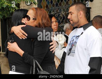 Lezcano Lima, brother of former Major League Baseball player Jose Lima  escorts distraught family members to the wake for Lima at Coppola-Migliore  Funeral Home in the Queens Borough of New York on