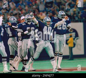 Miami Dolphins running back Terry Kirby (43) fumbles under pressure from  Dallas Cowboys Brock Marion (31), Bill Bates (40) and Leon Lett (78) in the  first quarter in Irving, Texas, Nov. 25