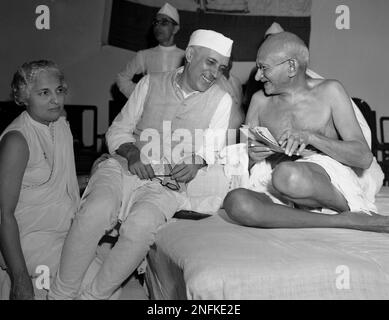 A bespectacled Mohandas Gandhi, the Mahatma, who eventually led India to its independence, laughs with the man who was to be the nation's first prime minister, Jawaharlal Nehru, at the All-India Congress committee meeting in Bombay, India, on July 6, 1946. Pictured to Nehru's left is Madam Vijaya Lakshmi Pandit. Nehru took office as president of the Congress during the session. Gandhi's philosophy of non-violent resistance, including civil disobedience and fasts, drove India to independence in 1947 after nearly 200 years of British rule. The father of modern India, the Mahatma, which means gre