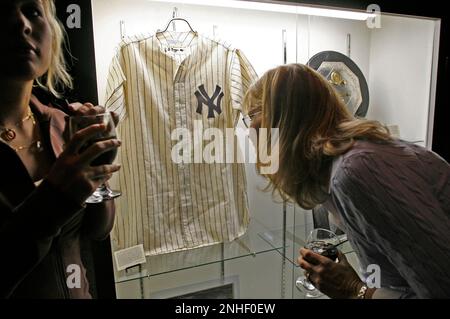 In this April 10, 2013 photo, David Kohler, president and chief executive  of SCP Auctions, looks over a New York Yankees jersey purportedly worn by  Reggie Jackson during the 1977 World Series