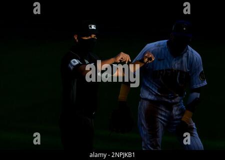 Umpire Erich Bacchus stands on the field between innings of the first  baseball game of a doubleheader between the Pittsburgh Pirates and the  Washington Nationals, Saturday, April 29, 2023, in Washington. (AP