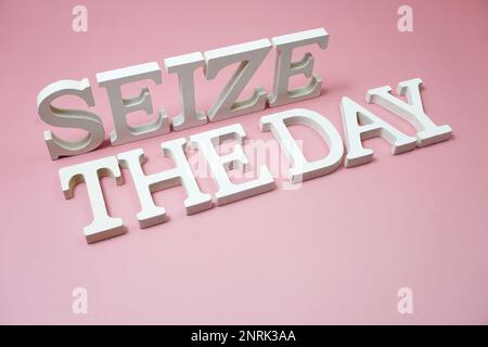 Aprovecha las letras del alfabeto del día sobre fondo rosa Foto de stock