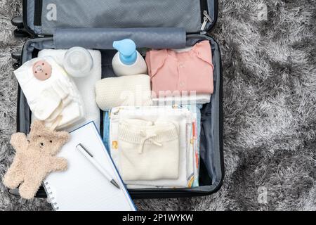 Bolsa abierta para el hospital de maternidad. Maleta de ropa de bebé  preparada para el nacimiento del recién nacido. Concepto de prepararse para  el hospital de maternidad, embalaje Fotografía de stock 