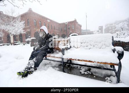 Timothy McBride sits on a bench at the edge of Heritage Square in downtown Flagstaff, Ariz., Monday, March 2, 2015. Heavy snow forced the closure of schools, government offices in northern Arizona and the Grand Canyon's visitor centers Monday while rain fell in the state's desert terrain. (AP Photo/Arizona Daily Sun, Jake Bacon)