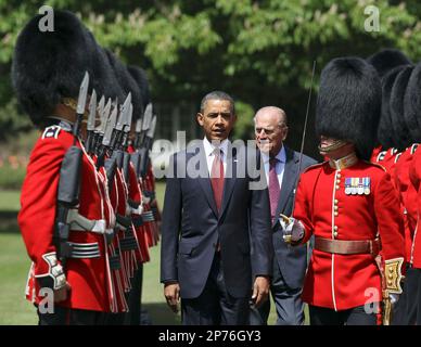 US President Barack Obama, center left, inspects the guard of honor 1st battalion Scots Guards with Britain's Prince Philip, center right, at Buckingham Palace in London, on Tuesday May 24, 2011. President Barack Obama and first lady Michelle Obama traded-in Irish charm for the pomp and pageantry of Buckingham Palace Tuesday as they opened a two-day state visit to Britain at the invitation of Queen Elizabeth II. (AP Photo/Adrian Dennis, Pool)