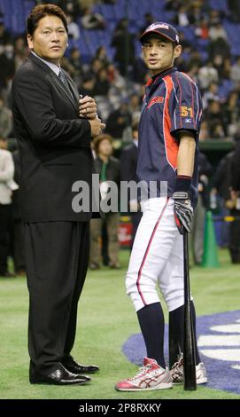 Former major league MVP player Jose Canseco, left, and former Seattle  Mariners closer Kazuhiro Sasaki, both wearing Yokohama BayStars jerseys,  react after attending the first-pitch ceremony for a Japanese professional  baseball game