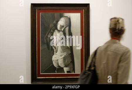 A woman passes the photo 'Die Puppe' (The Doll) by artist Hans Bellmer during a press preview of the exhibition 'Surreal Words' of the Scharf-Gerstenberg Collection in Berlin, Thursday, July 10, 2008. (AP Photo/Markus Schreiber)