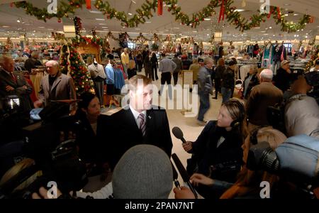 Delores Whitcomb, left, hugs an unidentified Von Maur associate at the Von  Maur department store in Westroads Mall Thursday Dec. 20, 2007 in Omaha,  Neb. The store opened for business after being