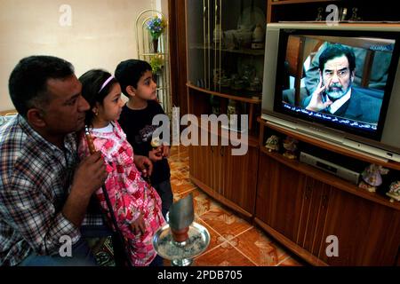 An Iraq family watch the trial of former Iraqi dictator Saddam Hussein on a state television, in Baghdad, Tuesday, Feb. 28, 2006. The trial of Saddam Hussein continued on Tuesday as defense lawyers attended a session, ending a month long boycott of the proceedings. Saddam and seven co-defendants have been on trial since Oct. 19 in the killing of nearly 150 people from the town of Dujail after a 1982 assassination attempt against Saddam there. (Ap Photo/Hadi Mizban) .