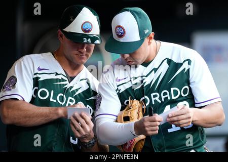 Colorado Rockies' Cole Tucker (3) celebrates with third base coach/infield  coach Warren Schaeffer (34) after hitting a solo home run during the third  inning of a spring training baseball game against the