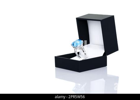 Joya de topacio azul o anillo de gemas en caja de joyas azul oscuro. Colección de accesorios de piedras preciosas naturales. Toma de estudio Foto de stock