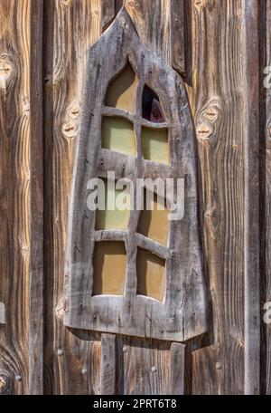 Primer plano de una ventana de madera ornamentada en un ambiente soleado Foto de stock