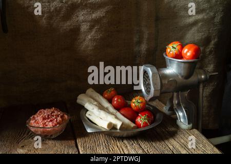 Verduras maduras para cocinar condimentos picantes. Tomates y raíz de rábano picante con ajo sobre fondo oscuro Foto de stock