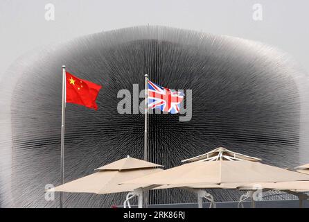 Bildnummer: 53976279 Datum: 23.04.2010 Copyright: Imago/Xinhua (100426) -- SHANGHAI, 26 de abril de 2010 (Xinhua) -- Las banderas nacionales de China y Gran Bretaña se ven frente al pabellón del Reino Unido en el Parque de la Exposición Mundial en Shanghai, este de China, 23 de abril de 2010. Gran Bretaña ha establecido en la Expo de Shanghai un Palacio de Cristal -- un cubo deslumbrante formado por más de 60.000 varillas acrílicas delgadas y transparentes que contienen semillas de diferentes plantas que fueron recolectadas en un proyecto de biodiversidad. el pabellón, apodado diente de león por el público chino, pretende transmitir la idea de construir sobre el pasado, moldeando nuestro futuro. Foto de stock