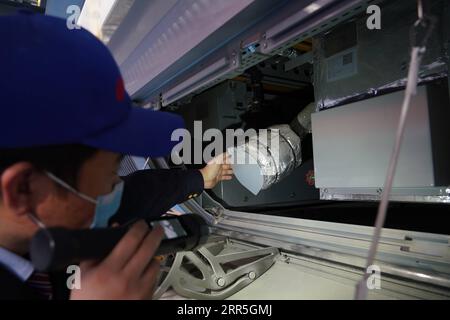 210107 -- BEIJING, Jan. 7, 2021 -- A staff checks the high-speed Electric Multiple Unit EMU named Fuxing in China Railway Beijing Group Co., Ltd. in Beijing, capital of China, on Jan. 6, 2021. China on Wednesday debuted a high-speed Electric Multiple Unit EMU that can operate under temperatures as low as minus 40 degrees Celsius in Beijing. The EMU, named Fuxing, has a designed speed of 350 km per hour. It is expected to run on the high-speed railway between Beijing and Harbin, capital of China s northernmost province Heilongjiang, according to Zhou Song, with China Railway Beijing Group Co., Stock Photo