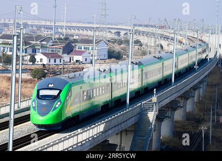 210119 -- SUZHOU, Jan. 19, 2021 -- A train runs through Huangjing Township of Taicang, east China s Jiangsu Province, Jan. 19, 2021. China will implement a new railway operating plan starting Jan. 20, 2021, to further improve the country s railway passenger and freight transport capacity, according to the national railway operator. A total of 325 passenger trains, as well as 114 freight trains for major cargo transport lines, will be added under the new plan, said the China State Railway Group Co., Ltd. Photo by /Xinhua CHINA-NEW RAILWAY OPERATING PLAN CN JixHaixin PUBLICATIONxNOTxINxCHN Stock Photo