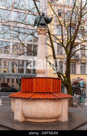 Munich, Alemania - 25 de diciembre de 2021: El Wolfsbrunnen es una fuente en el centro de Munich. Fue creado en 1904 por los escultores Heinrich Düll y. Foto de stock