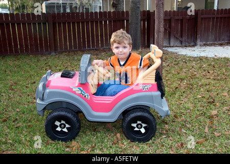 Niño de 3 años que viajaban en un coche de juguete alimentado por batería Foto de stock