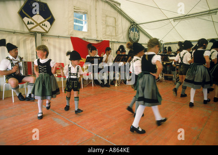 Los niños bailando en traje tradicional bávaro de música tradicional en el Oktoberfest en Munich