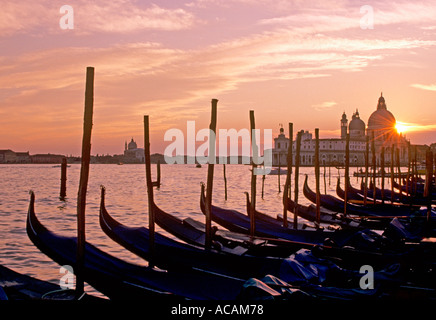 Famosa vista de las góndolas al atardecer en el Lido di San Marco, con la Basílica di Santa Maria della Salute Venecia Italia