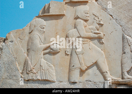 Los esclavos y los soldados se llevan regalos para el emperador persa Darío en las escaleras del Palacio de Persépolis Irán Foto de stock