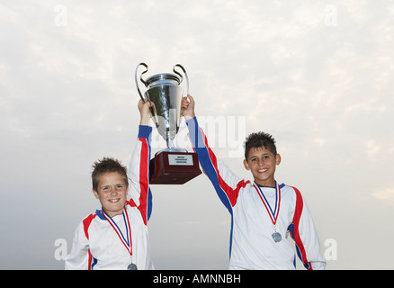 Jugadores de fútbol con medallas de oro y el trofeo