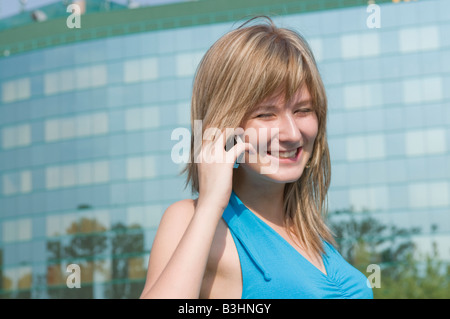 Mujer joven con teléfono celular hablando outdoor Foto de stock