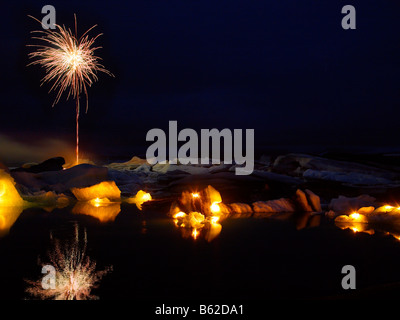 Fuegos artificiales sobre los icebergs con velas en la Laguna glaciar Jokulsarlon, Glaciar Breidamerkurjokull, Islandia