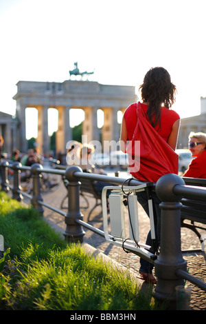 Joven mujer en la Puerta de Brandenburgo en Berlín, Alemania