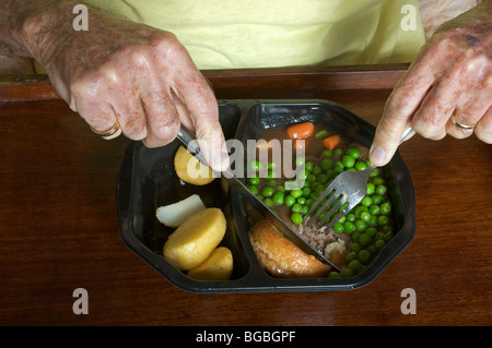 Viejo pensionista comiendo un ojo aves vaca tradicional comida preparada Foto de stock