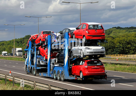 Transportador de coches hgv camión camión de primera línea y remolque semiarticulado cargado con coches nuevos que conducen a lo largo de la carretera de autopista orbital M25 Essex Inglaterra Reino Unido Foto de stock