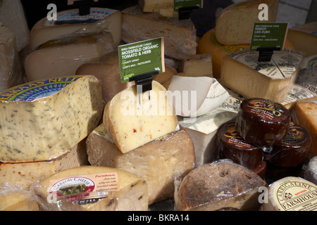 Selección de quesos incluyendo queso irlandés en una especialidad puesto de comida en un mercado al aire libre en el Condado de Down en Holywood Foto de stock