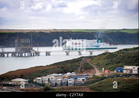 Vista desde Milford Haven con amarres de refinería de petróleo y un barco de pasajeros Irish Ferries Gales UK