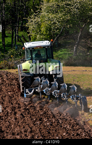 Los tractores que están arando los campos coloridos en primavera. Aberdeenshire, Escocia. Foto de stock