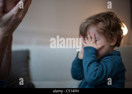 Niño y padre jugando peek-a-boo
