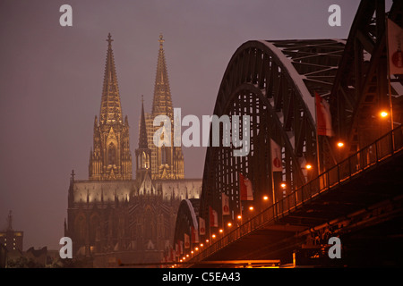 La Catedral de Colonia y el puente Hohenzollern encendida en invierno, Colonia, Renania del Norte-Westfalia, Alemania, Europa Foto de stock
