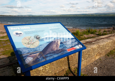 Un signo da información acerca de los delfines que puede verse desde el punto de Chanonry en el Moray Firth. Foto de stock
