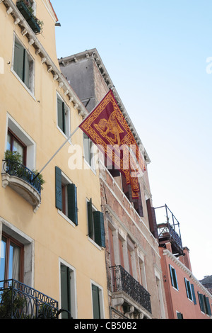 Una antigua casa en Venecia enarbola la bandera de la Serenísima República - El león de San Marcos Foto de stock