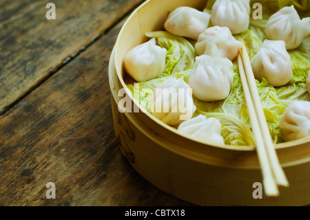Dumpling asiática en la vaporera con repollo Foto de stock