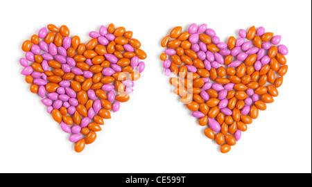 Dos corazones realizados por coloridos caramelos dragee aislado sobre fondo blanco.