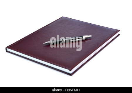 Pen tumbado en la Borgoña scrapbook, portátil, aislado Foto de stock