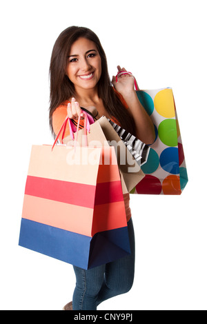 Hermosa feliz sonriente joven sobre la juerga de compras llevar coloridas bolsas con mercancía, aislado. Foto de stock