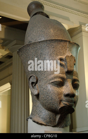 Cabeza de granito rojo monumental estatua de un rey egipcio portando la doble corona. Probablemente Amenhotep III. Alrededor de 1390 A.C.